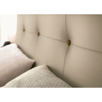 Wooden bed with upholstered headboard and Harmony Le Fablier buttons.